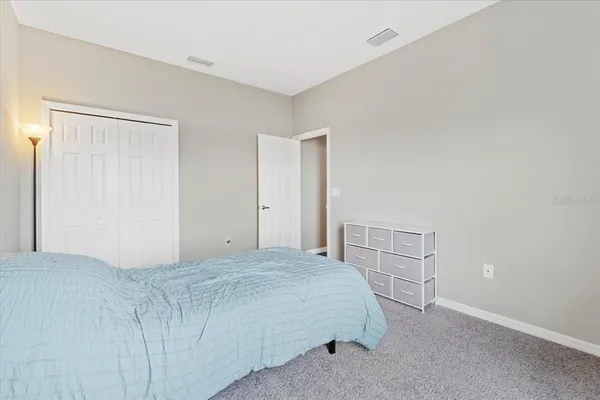 a bedroom with a bed and cabinets