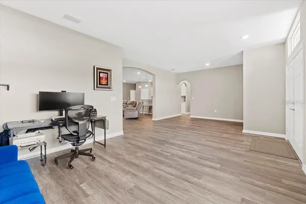 a view of a workspace with wooden floor and a workspace