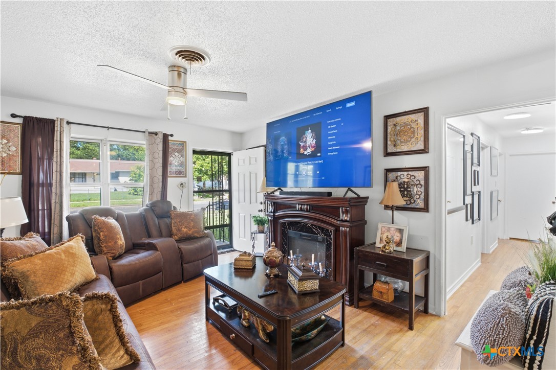 503 Cardinal Avenue Killeen, TX 76541 - Photo 6 of 26 a living room with furniture a flat screen tv and a fireplace