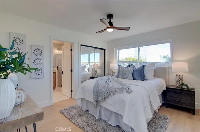 a bedroom with a bed and a potted plant