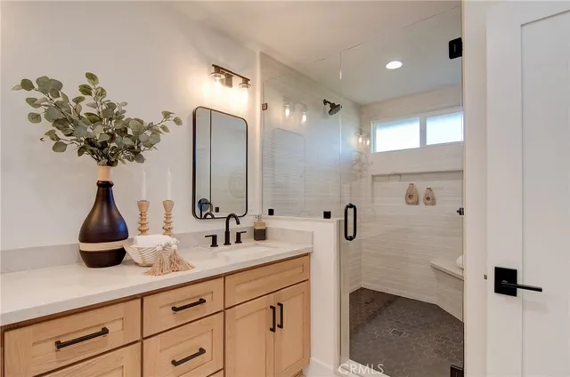 a bathroom with a double vanity sink and a mirror