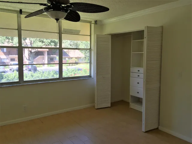 a view of a room with wooden floor and a window