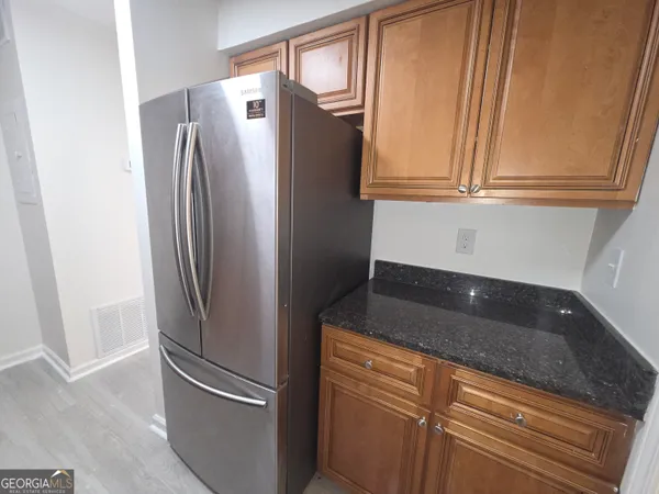 a close view of a refrigerator in kitchen and an oven