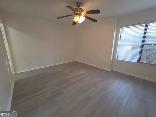 a view of a room with wooden floor and a window