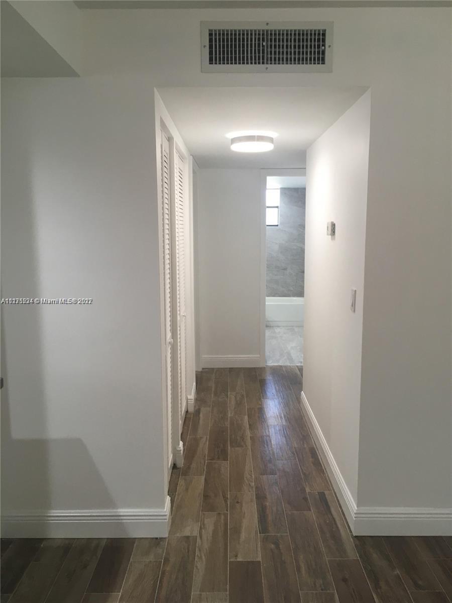 7915 Southwest 86th Street, Unit 723 Miami, FL 33143 - Photo 5 of 14 a view of hallway with wooden floor