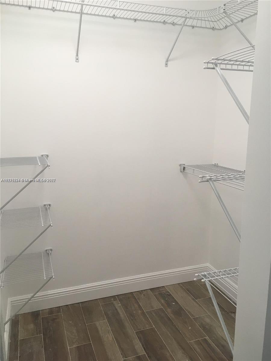 7915 Southwest 86th Street, Unit 723 Miami, FL 33143 - Photo 9 of 14 a view of a room with racks on the wall