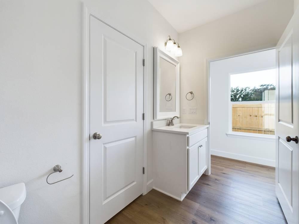 21 D 5th Avenue Shalimar, FL 32579 - Photo 15 of 18 a bathroom with a sink mirror and a toilet