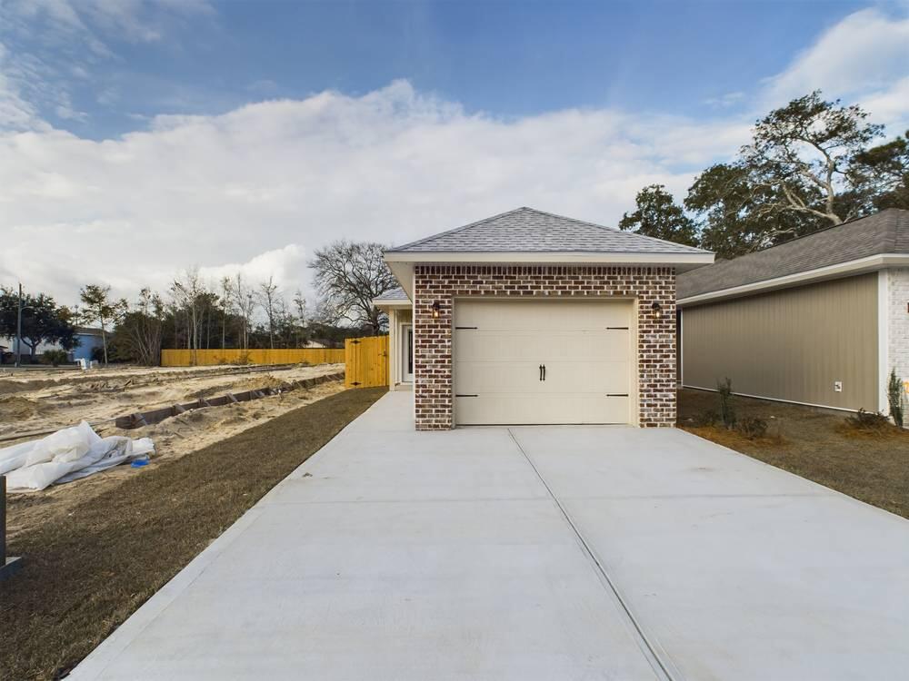 21 D 5th Avenue Shalimar, FL 32579 - Photo 3 of 18 a front view of a house with a yard