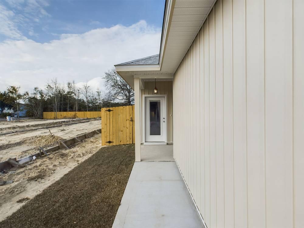 21 D 5th Avenue Shalimar, FL 32579 - Photo 4 of 18 a view of a pathway of a house with a yard