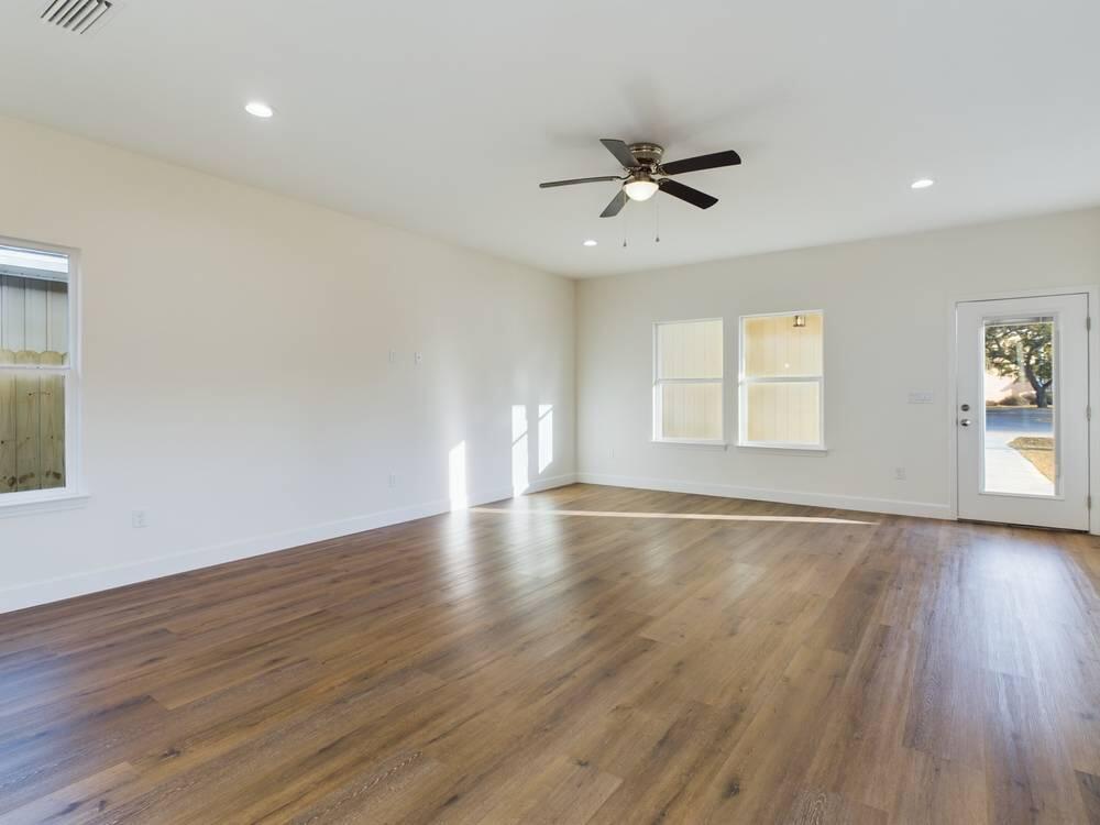 21 D 5th Avenue Shalimar, FL 32579 - Photo 6 of 18 a view of an empty room with wooden floor and a window