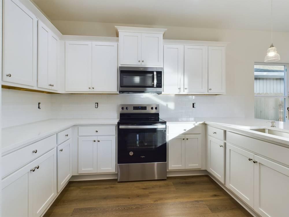21 D 5th Avenue Shalimar, FL 32579 - Photo 7 of 18 a kitchen with cabinets appliances a sink and a window