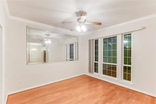 a view of a hallway with wooden floor and entryway