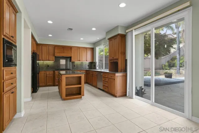 a kitchen with granite countertop stainless steel appliances and cabinets