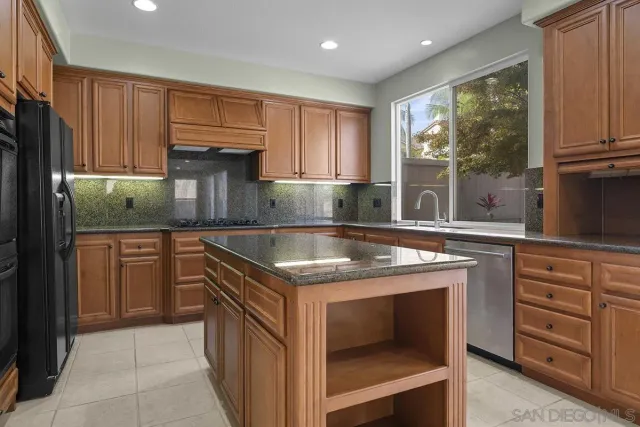 a kitchen with stainless steel appliances granite countertop a stove and a sink