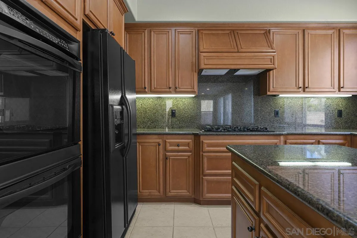 4418 Shorepointe Way San Diego, CA 92130 - Photo 15 of 65 a kitchen with granite countertop stainless steel appliances and cabinets
