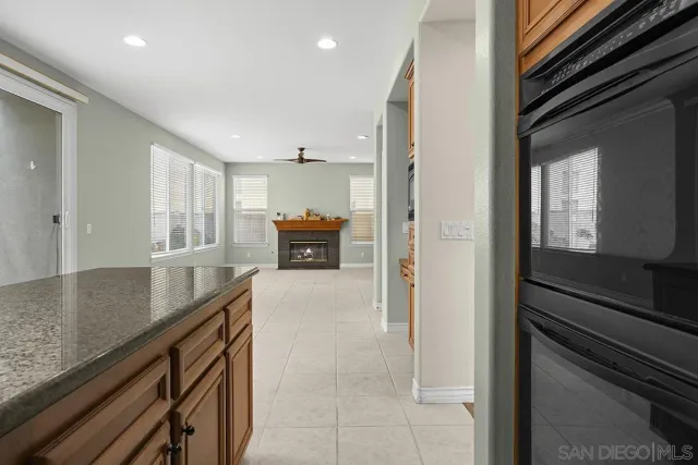 a kitchen with a sink a counter top space cabinets and stainless steel appliances