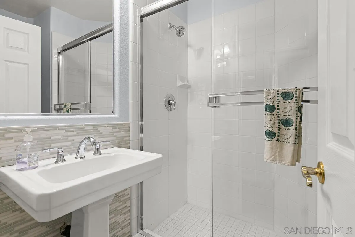 4418 Shorepointe Way San Diego, CA 92130 - Photo 28 of 65 a bathroom with a sink mirror and shower