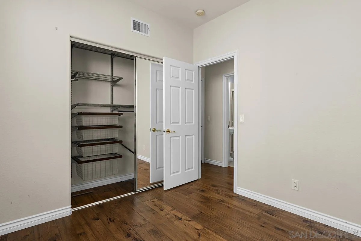4418 Shorepointe Way San Diego, CA 92130 - Photo 30 of 65 an empty room with wooden floor