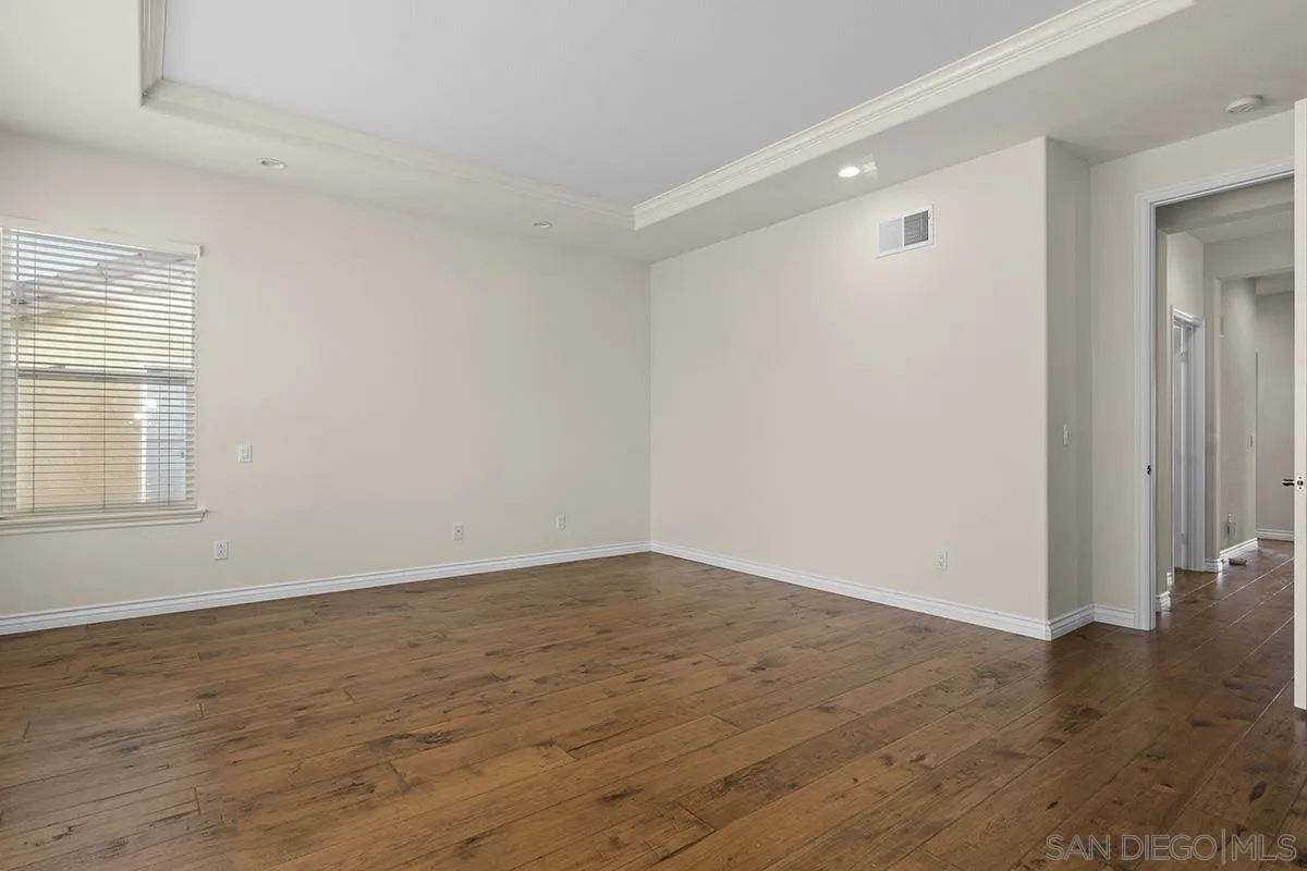 4418 Shorepointe Way San Diego, CA 92130 - Photo 34 of 65 a view of an empty room with wooden floor and a window