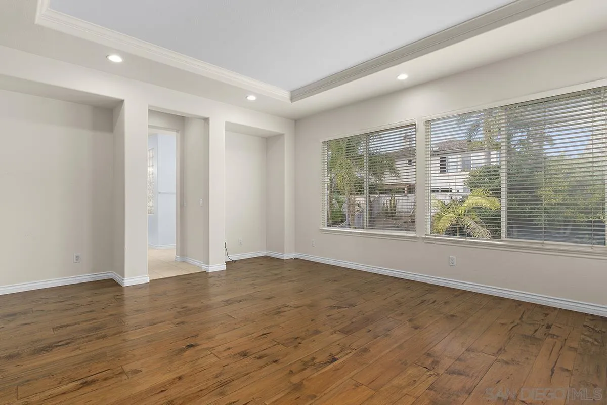 4418 Shorepointe Way San Diego, CA 92130 - Photo 35 of 65 a view of an empty room with wooden floor and a window