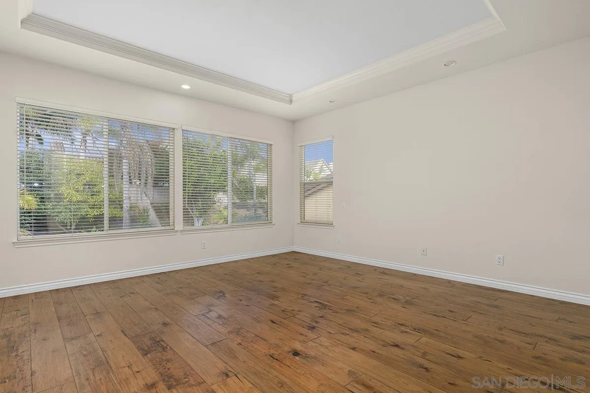 4418 Shorepointe Way San Diego, CA 92130 - Photo 36 of 65 a view of an empty room with wooden floor and a window