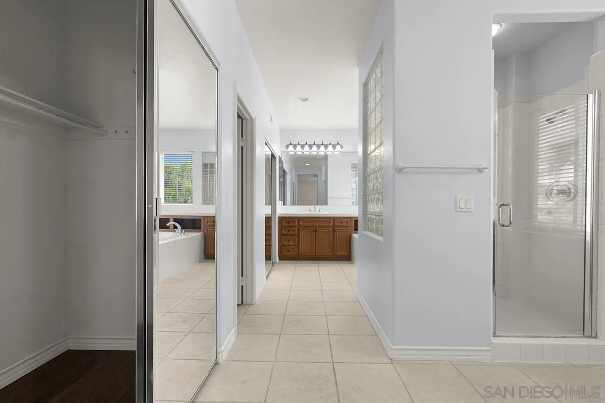 4418 Shorepointe Way San Diego, CA 92130 - Photo 38 of 65 a bathroom with a sink and a mirror