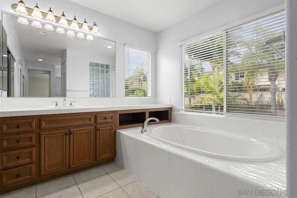 4418 Shorepointe Way San Diego, CA 92130 - Photo 39 of 65 a spacious bathroom with a tub sink and mirror