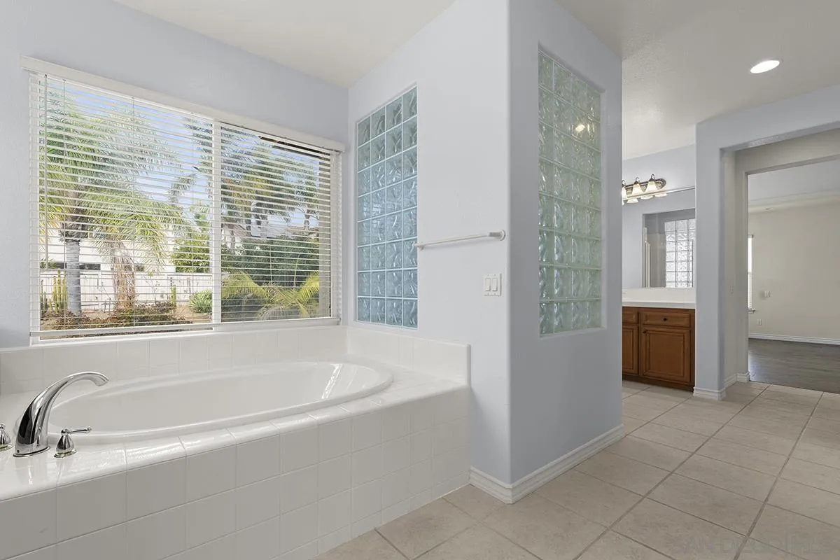 4418 Shorepointe Way San Diego, CA 92130 - Photo 40 of 65 a spacious bathroom with a tub shower and sink