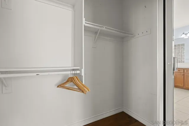 an empty room with wooden floor and closet