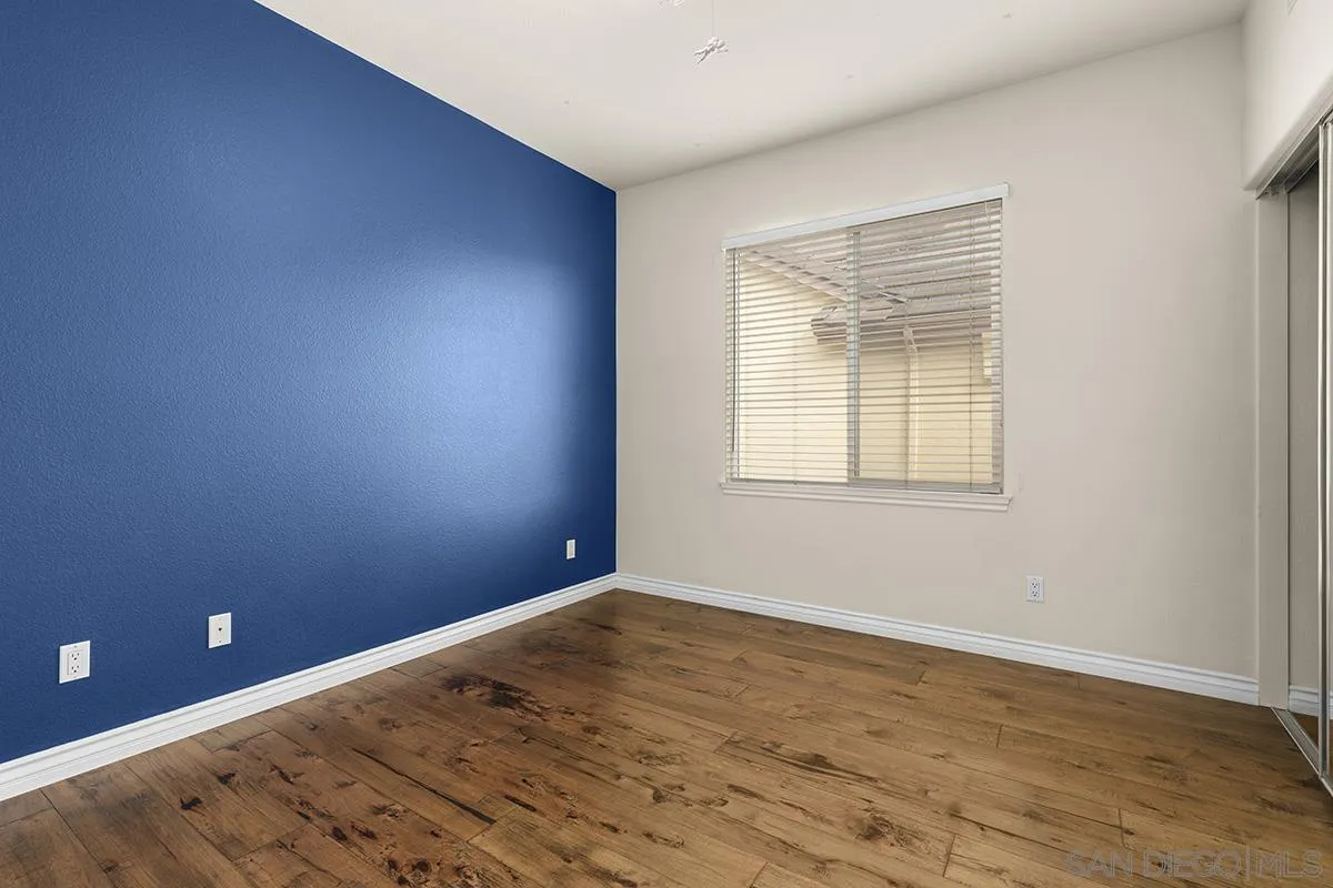 4418 Shorepointe Way San Diego, CA 92130 - Photo 51 of 65 an empty room with wooden floor and windows