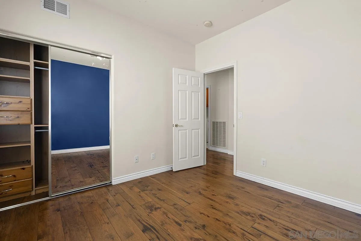4418 Shorepointe Way San Diego, CA 92130 - Photo 52 of 65 an empty room with wooden floor and closet