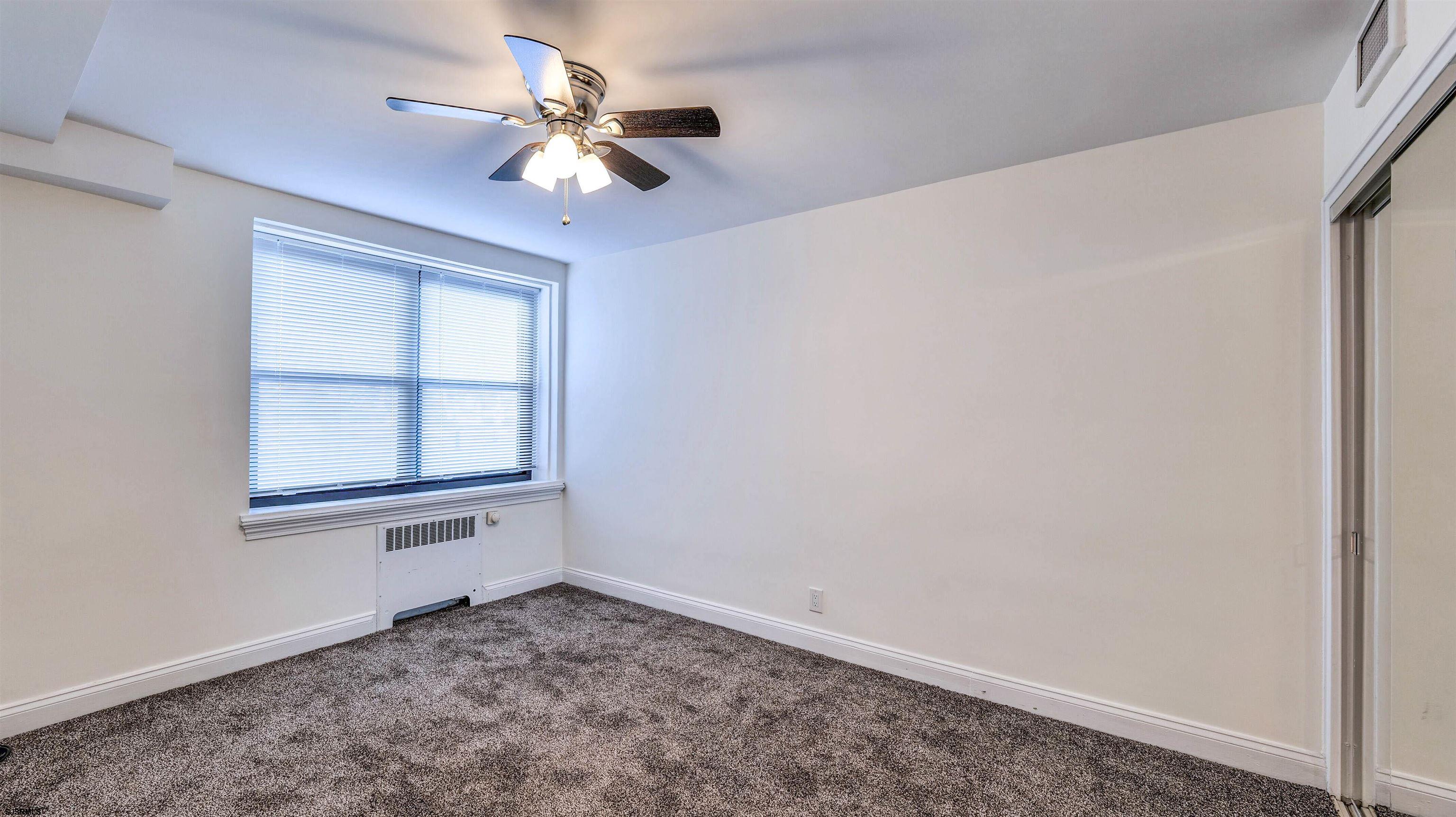 101 South Raleigh Avenue, Unit 226 Atlantic City, NJ 08401 - Photo 17 of 26 an empty room with a window and a ceiling fan