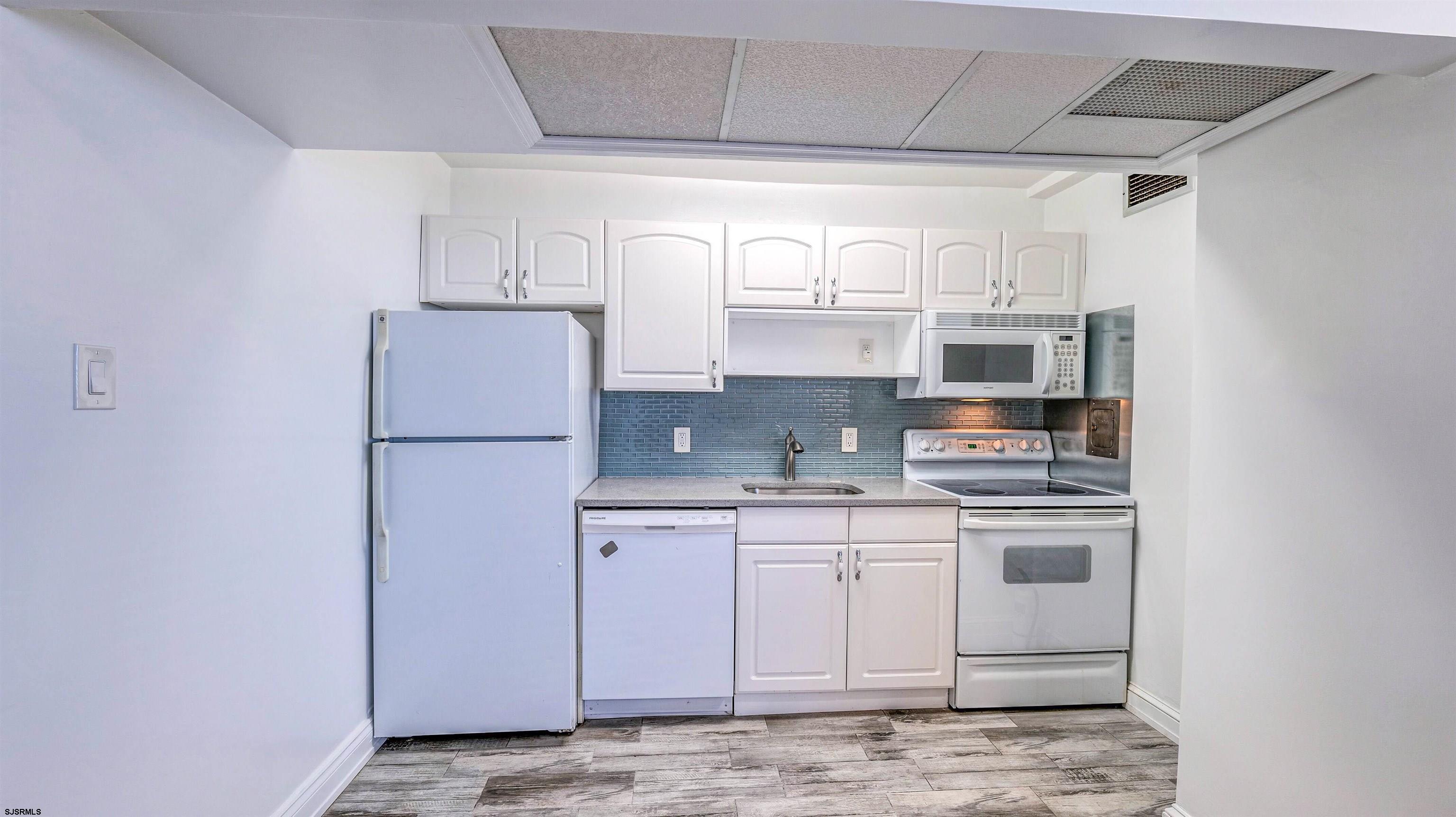 101 South Raleigh Avenue, Unit 226 Atlantic City, NJ 08401 - Photo 8 of 26 a kitchen with stainless steel appliances granite countertop a sink a stove a refrigerator and cabinets