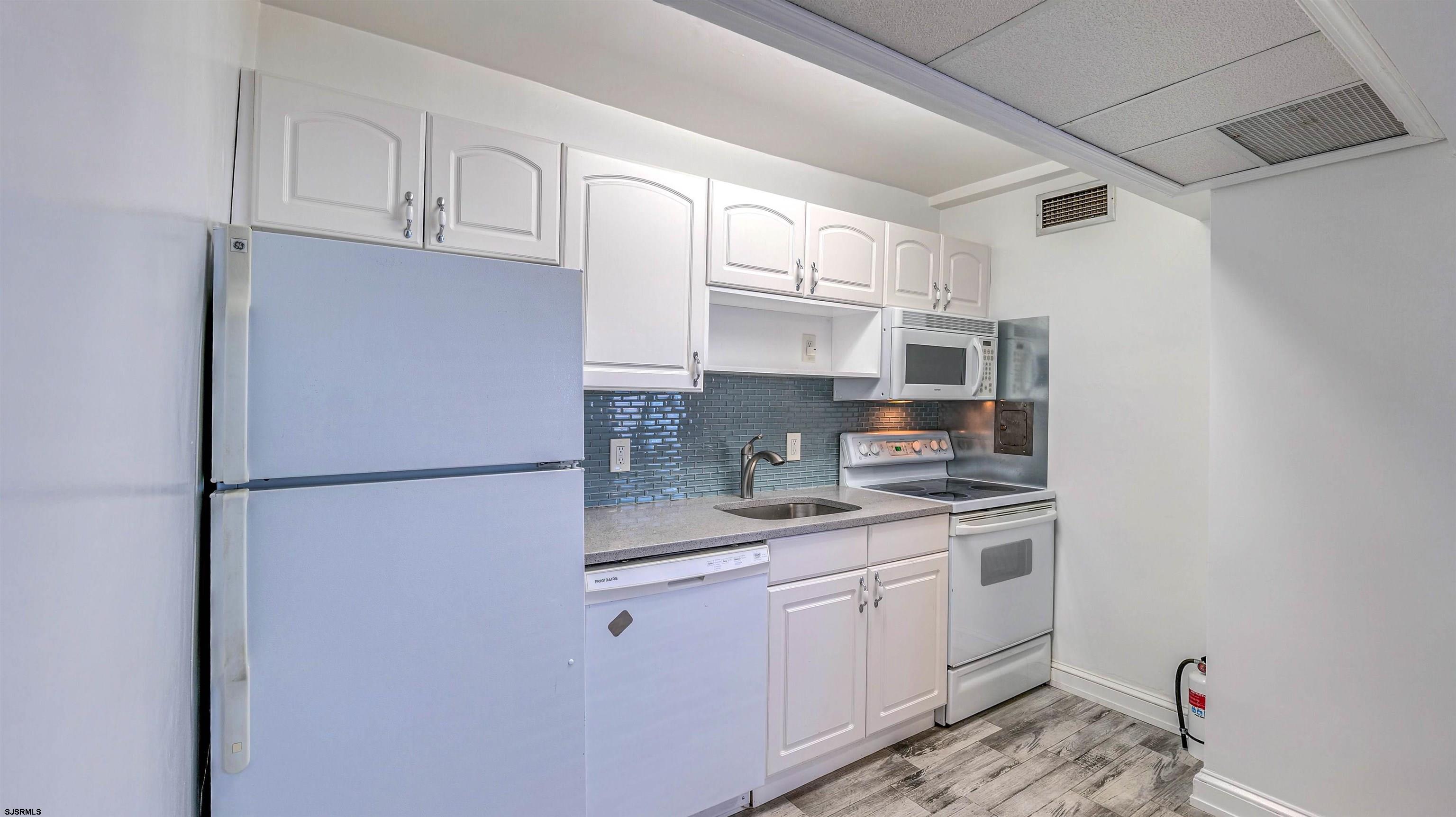 101 South Raleigh Avenue, Unit 226 Atlantic City, NJ 08401 - Photo 9 of 26 a kitchen with stainless steel appliances granite countertop a refrigerator sink and cabinets