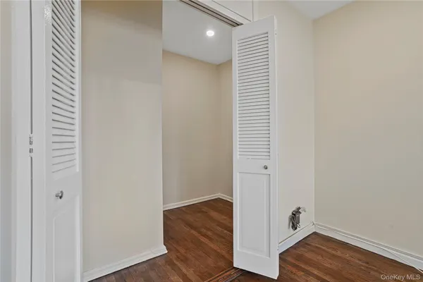 a view of hallway with wooden floor