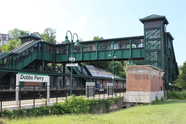 a view of city street with cars parked on the roadside