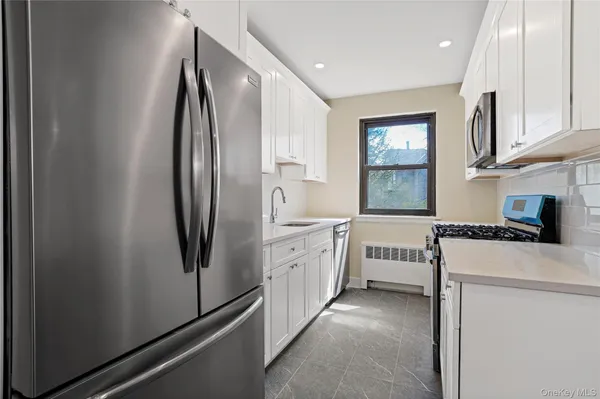 a kitchen with stainless steel appliances a refrigerator sink and cabinets