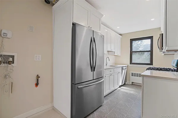 a kitchen with a refrigerator stove and sink