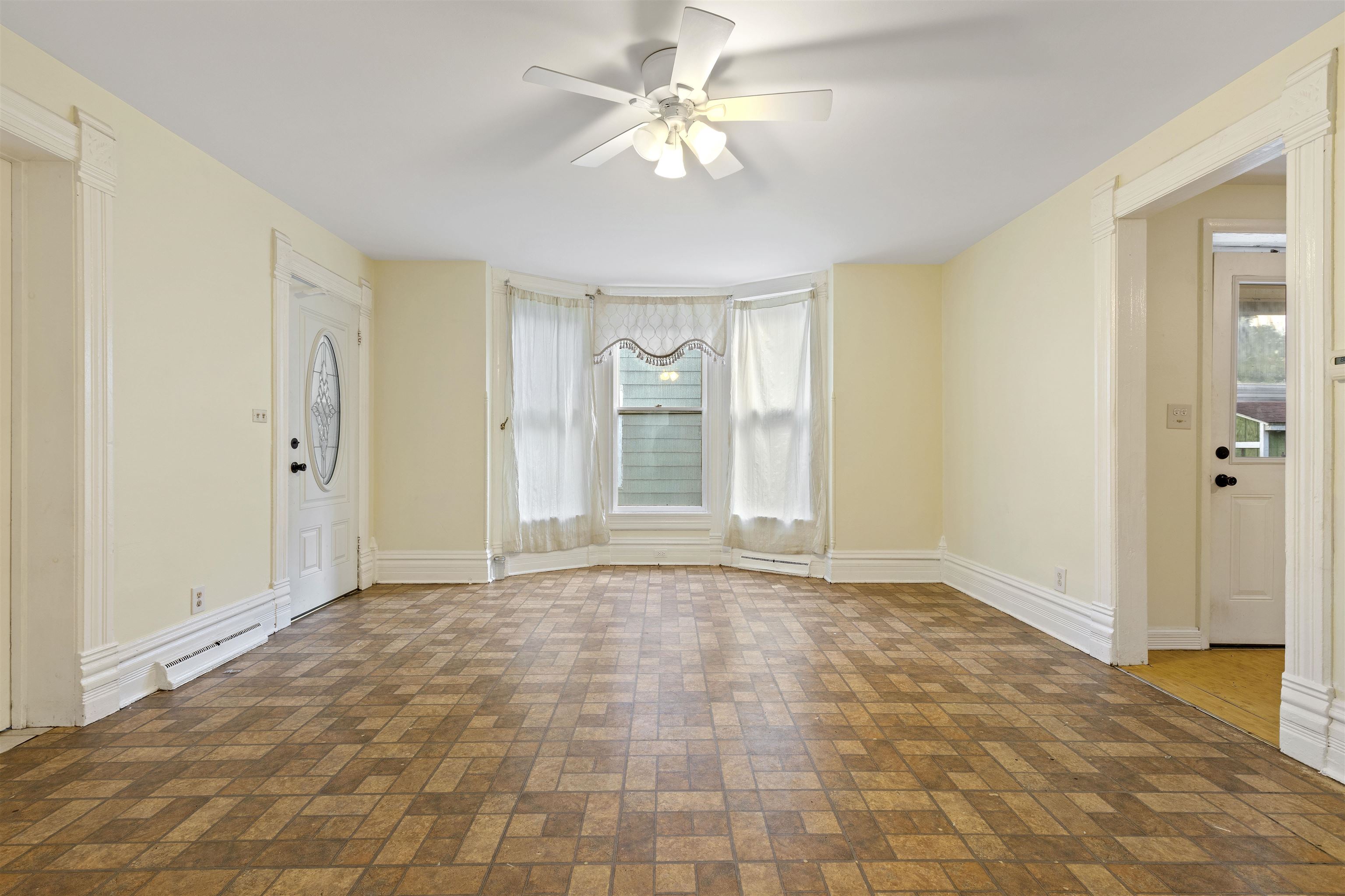 638 Grace Street Elgin, IL 60120 - Photo 4 of 12 a view of an empty room with window and a kitchen