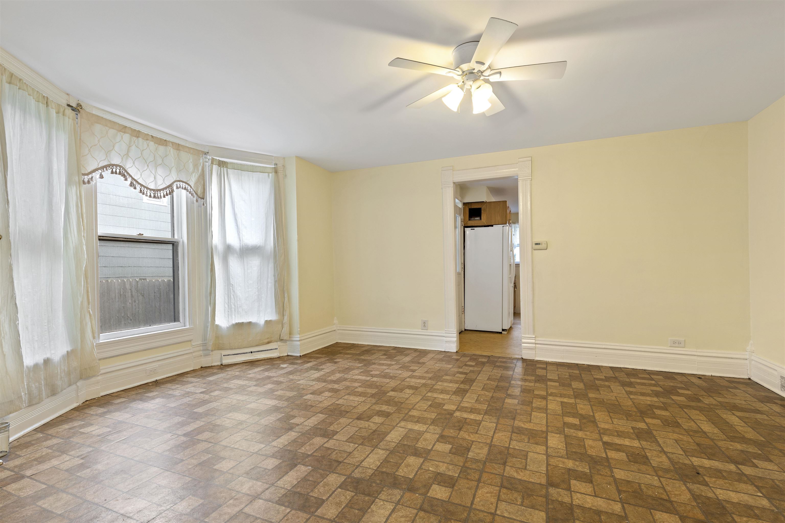 638 Grace Street Elgin, IL 60120 - Photo 5 of 12 a view of an empty room with window and a kitchen