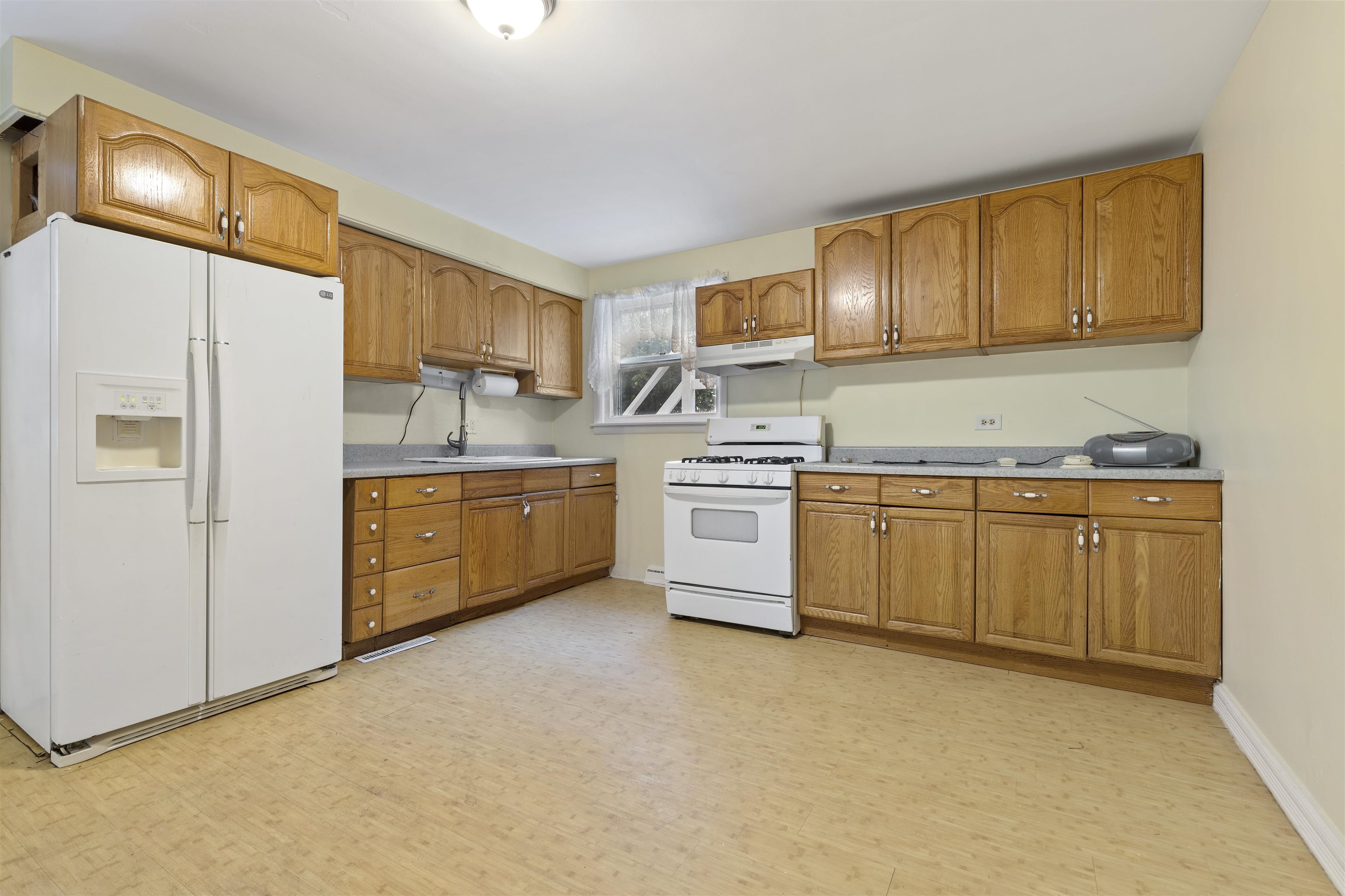 638 Grace Street Elgin, IL 60120 - Photo 6 of 12 a kitchen with stainless steel appliances white cabinets and a refrigerator