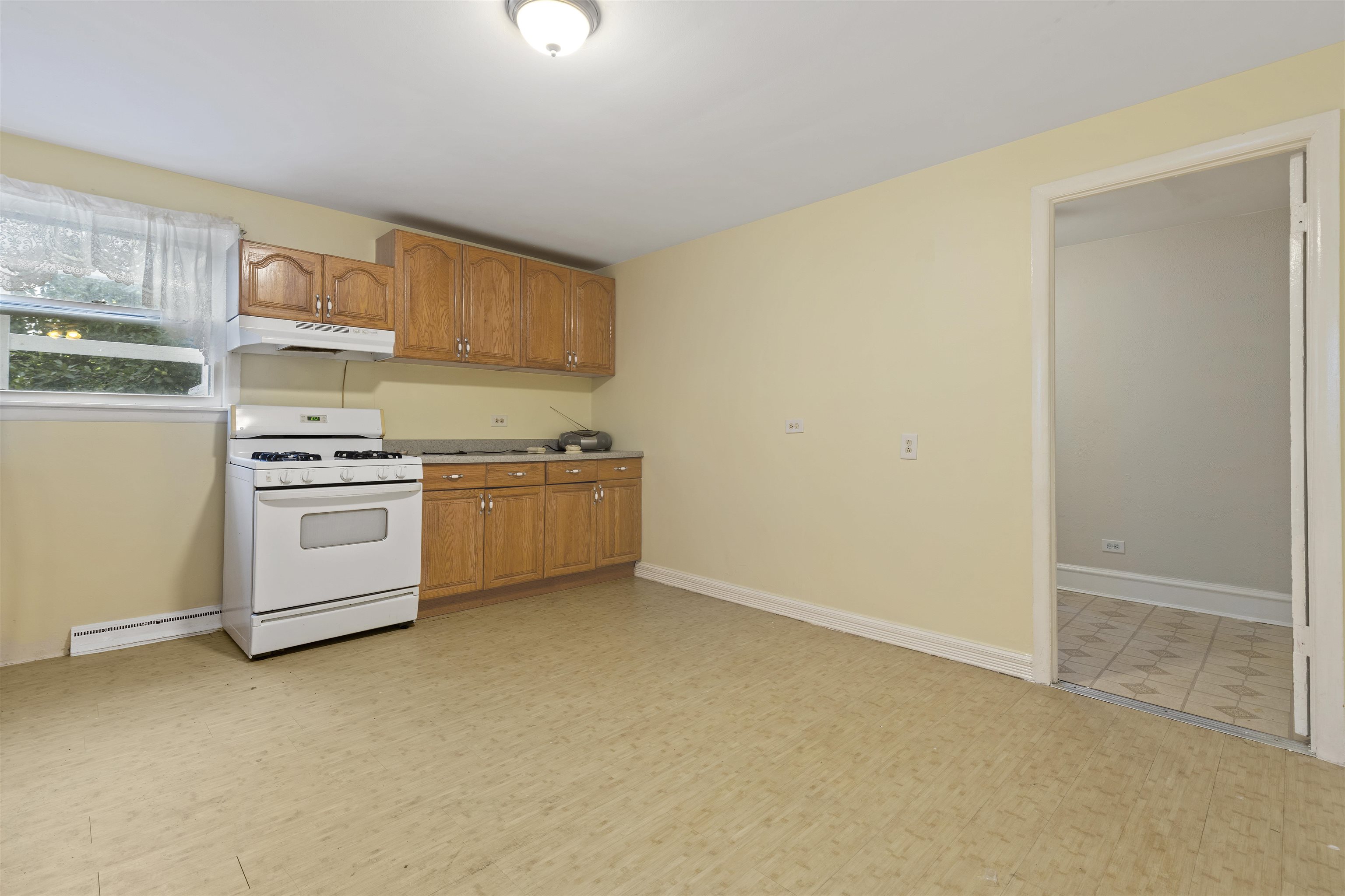 638 Grace Street Elgin, IL 60120 - Photo 7 of 12 a kitchen with white cabinets and white appliances