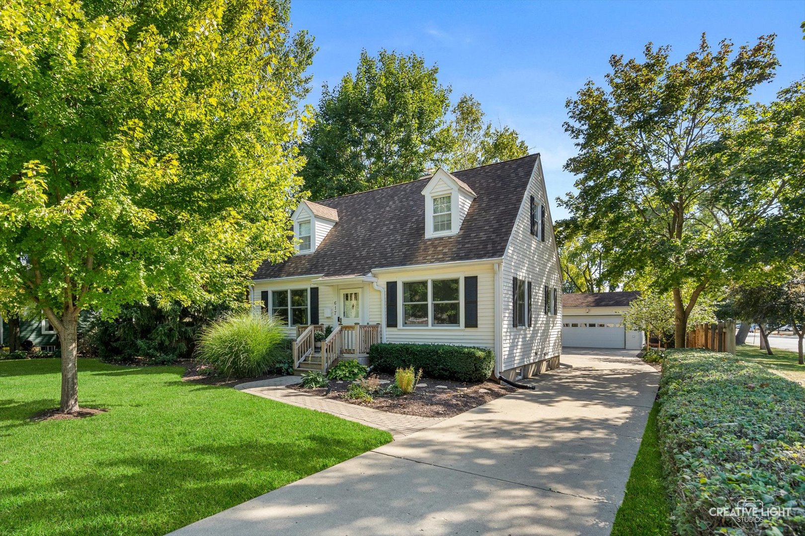 a front view of a house with a garden