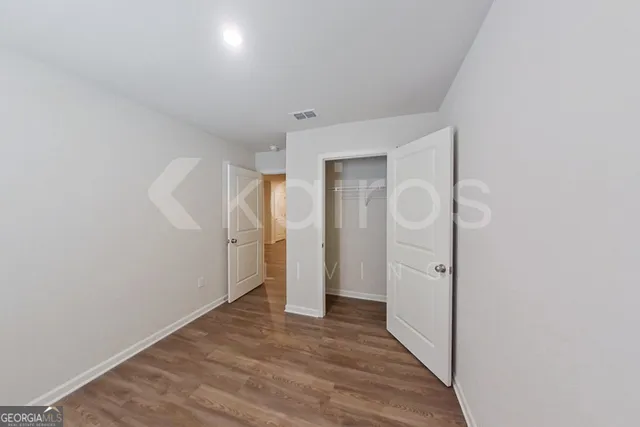 a bathroom with a granite countertop sink a toilet and a mirror