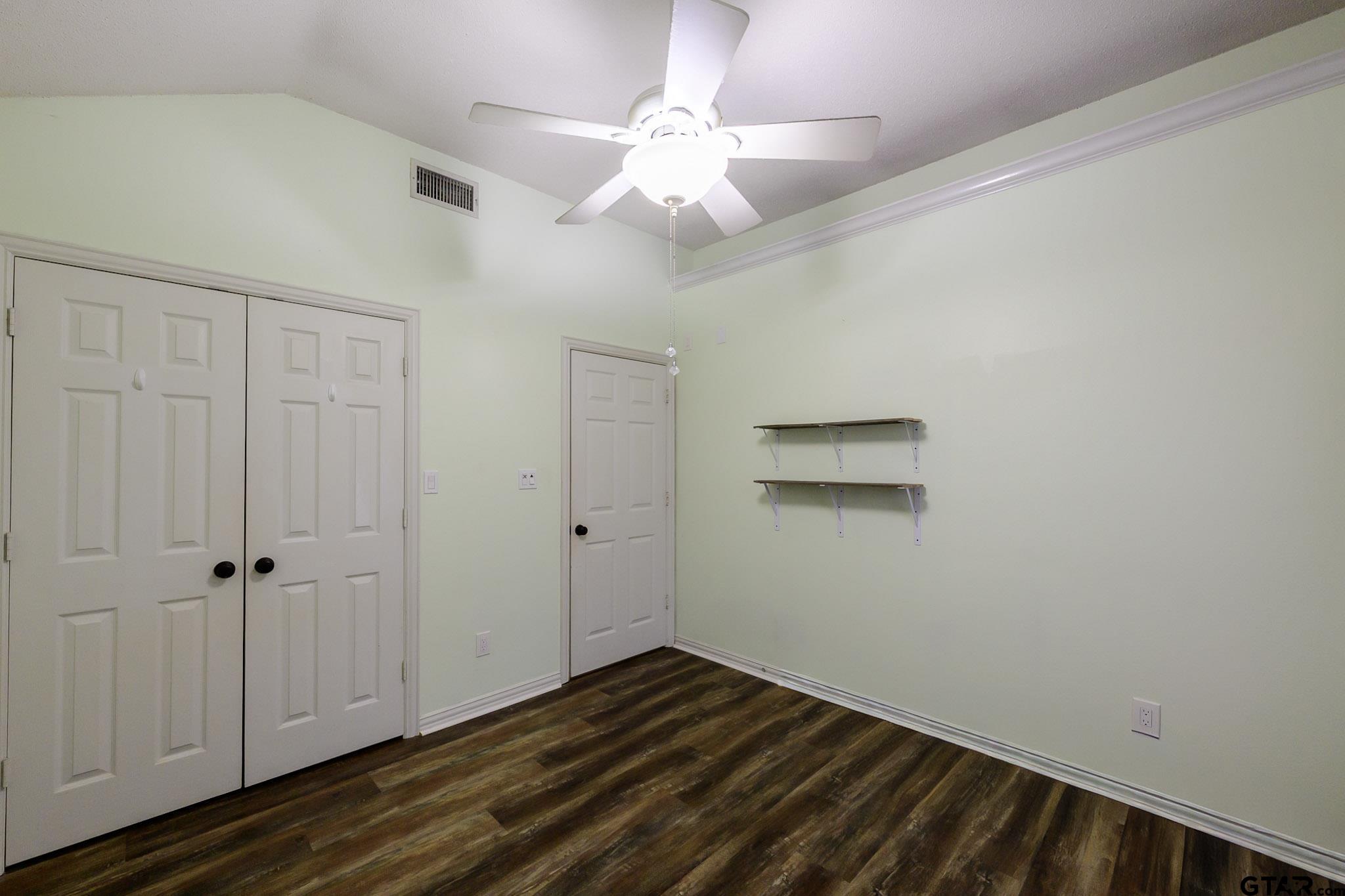 703 Kickapoo Road Chandler, TX 75758 - Photo 18 of 33 a view of an empty room with wooden floor
