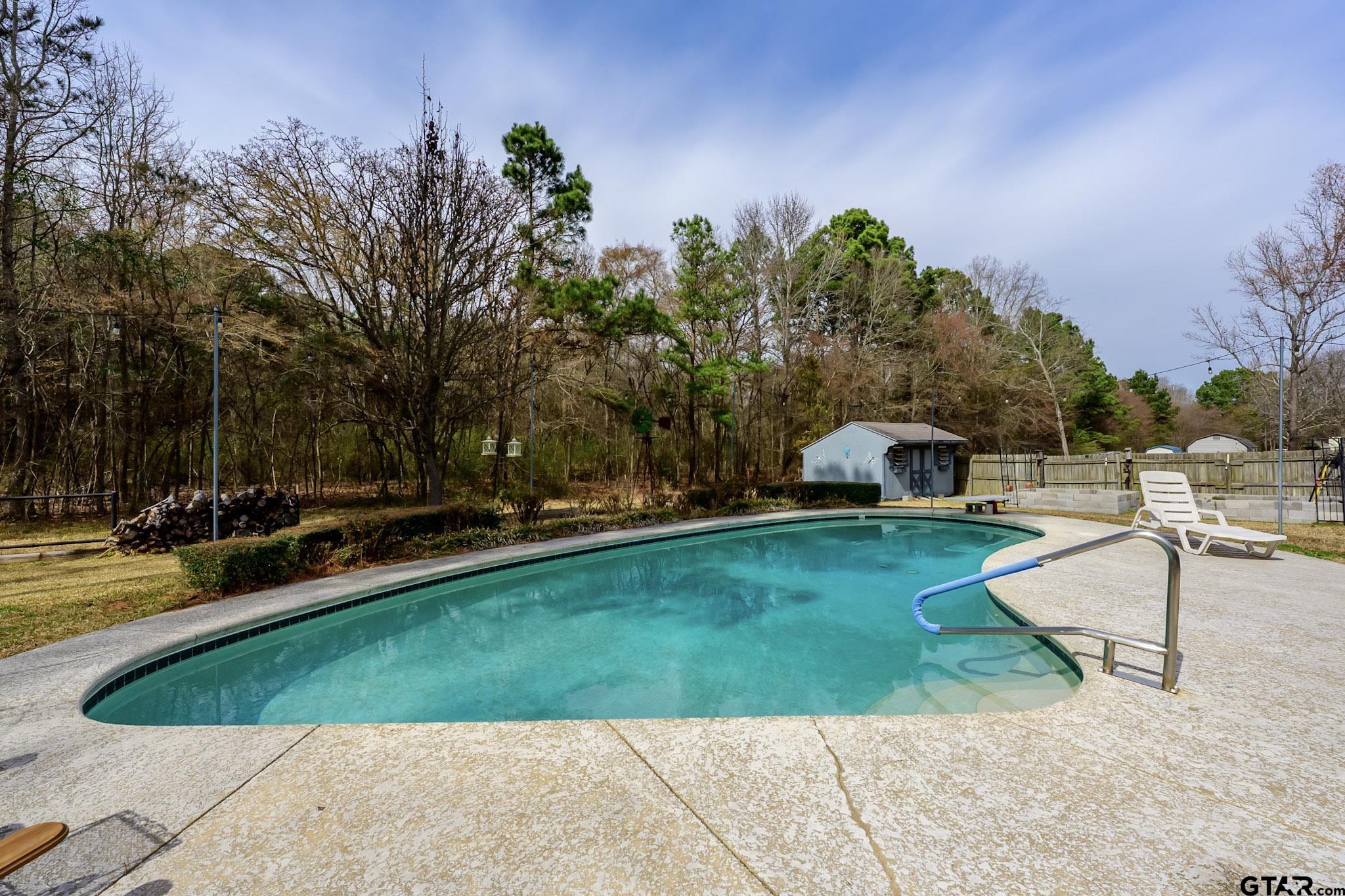 703 Kickapoo Road Chandler, TX 75758 - Photo 26 of 33 a view of a swimming pool with a patio
