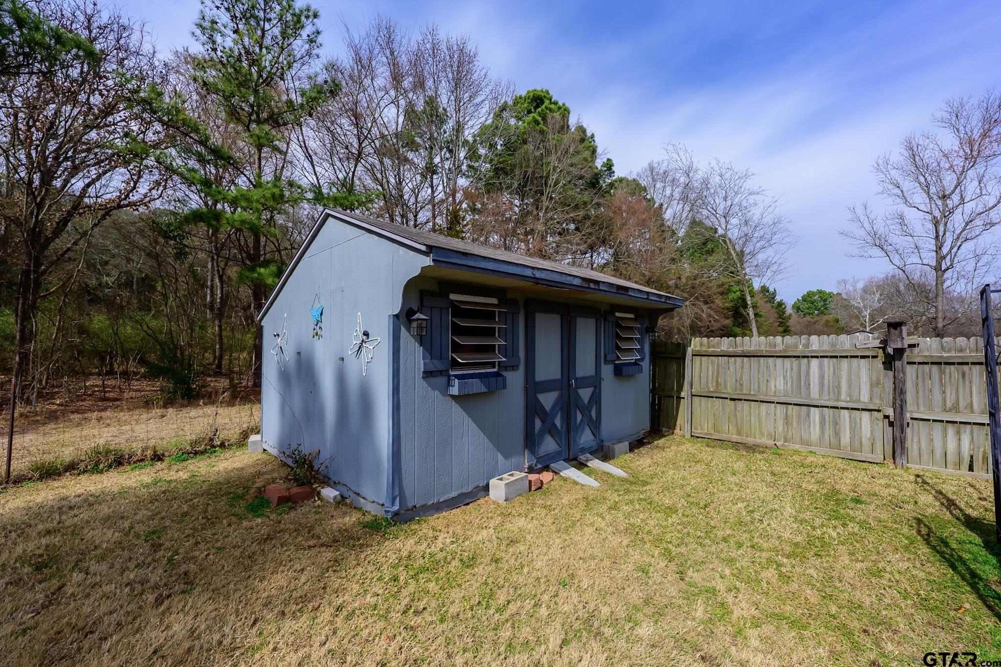 703 Kickapoo Road Chandler, TX 75758 - Photo 29 of 33 a view of a house with a small yard and wooden fence