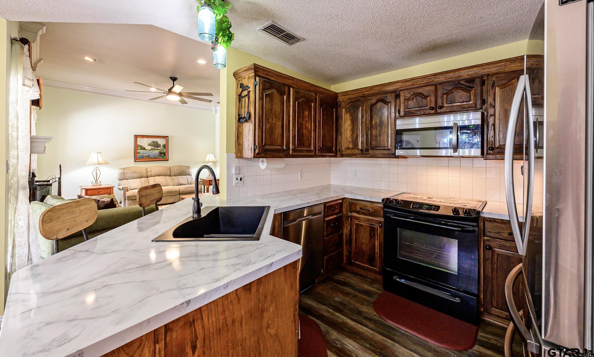 703 Kickapoo Road Chandler, TX 75758 - Photo 6 of 33 a kitchen with a stove and a sink