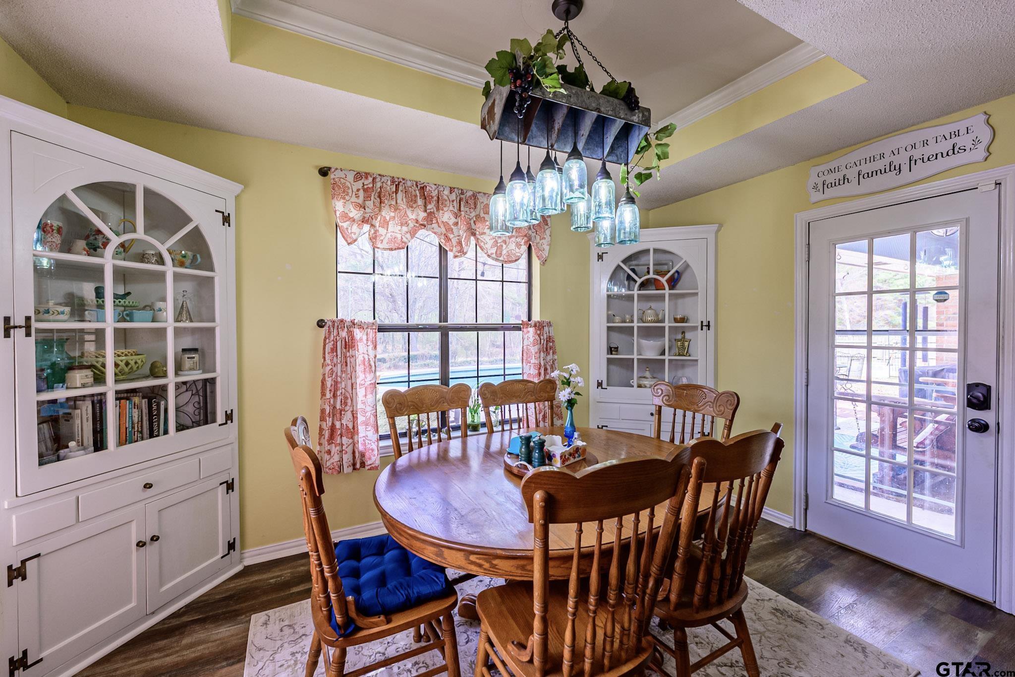 703 Kickapoo Road Chandler, TX 75758 - Photo 10 of 33 a view of a dining room with furniture window and wooden floor