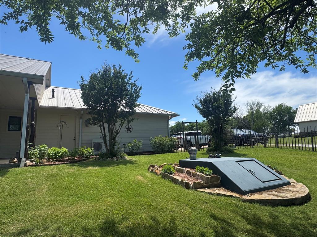 11918 Riek Road Krum, TX 76249 - Photo 8 of 40 a view of a backyard with table and chairs potted plants and large tree
